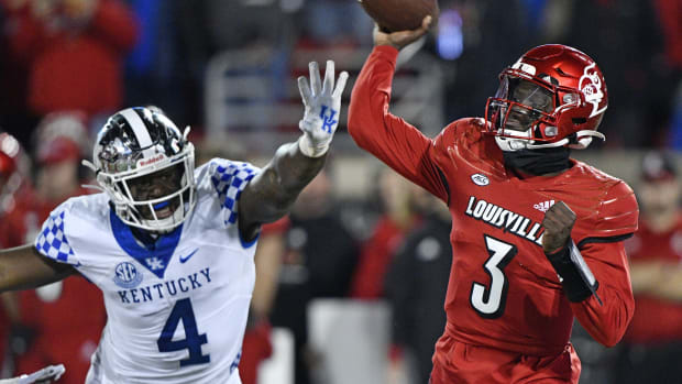 Nov 27, 2021; Louisville, Kentucky, USA; Louisville Cardinals quarterback Malik Cunningham (3) throws a pass against Kentucky Wildcats defensive end Josh Paschal (4) during the second quarter at Cardinal Stadium. Mandatory Credit: Jamie Rhodes-USA TODAY Sports